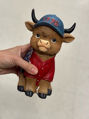 Handheld Bull Figurine with Blue '1776' Cap and Red Jacket